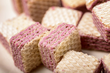 macro wafers stuffed with raspberry cream over wood