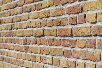 Orange brick wall texture with narrow depth of field
