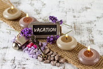 vacation concept with lavender, candles and door key