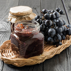 Onion jam with grapes in glass jars