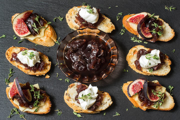 Variety of canape with onion jam, figs, cheese and thyme