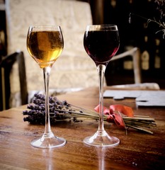 Pair of two glasses with liqueur on the wooden table