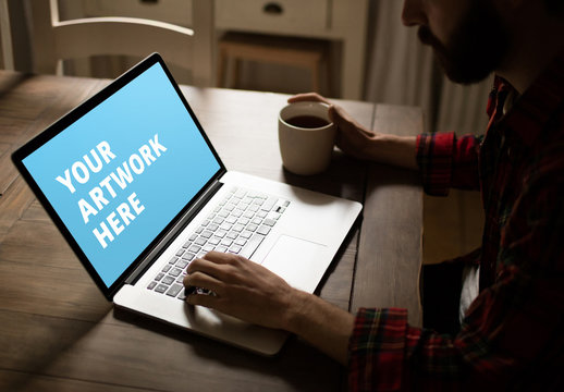 User with Laptop on Rustic Table Mockup
