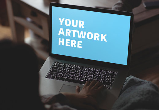 User with Laptop in Low Light Mockup