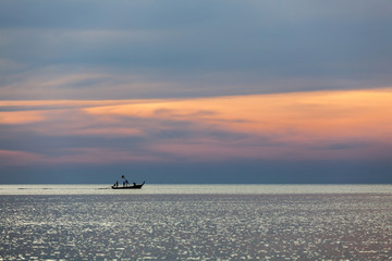 Thailand sunset view with fishing boat silhouette