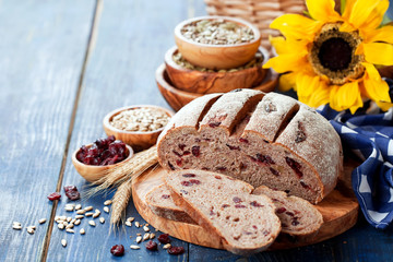 Homemade whole grain bread with sunflower seeds and dried cranberries, selective focus
