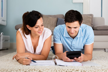 Couple Calculating Bills Together At Home