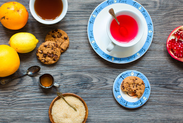 Fruit tea with lemon, milk,honey,orange, pomegranate, on a woode