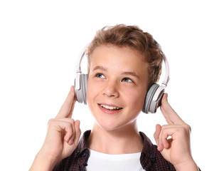 Fototapeta premium Boy listening music on light background