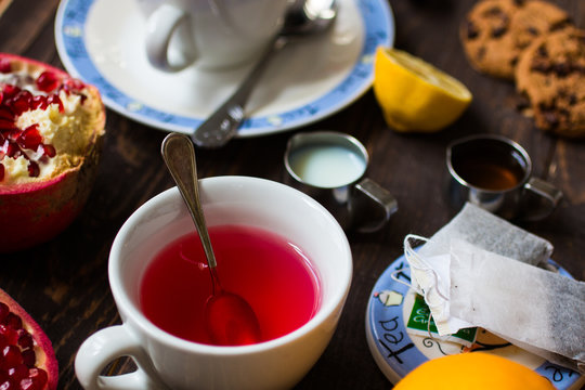 Fruit tea with lemon, milk,honey,orange, pomegranate, on a woode