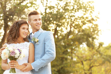 Portrait of beautiful wedding couple in park