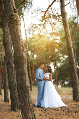Beautiful wedding couple in coniferous forest