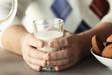 Senior man holding glass of milk