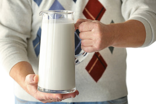 Senior man holding jug of milk
