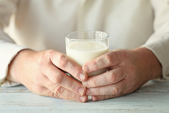 Senior man holding glass of milk