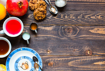Fruit tea with lemon, milk,honey,orange, pomegranate, on a woode