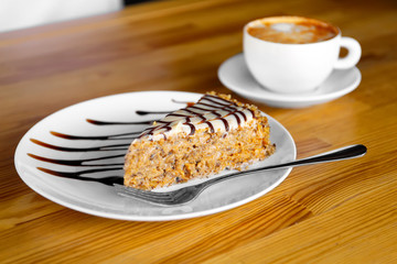 Plate with delicious dessert on wooden table at restaurant
