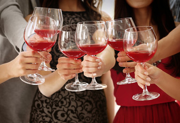 People toasting with glasses of red wine