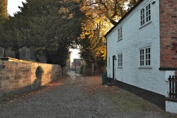 Dawn light through road towards old farm building