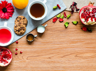 Fruit tea with lemon, milk,honey,orange, pomegranate, on a woode