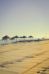 Beach umbrella chairs on the sunny blue sky beach outdoors background