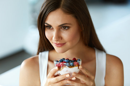 Beautiful Woman Eating Yogurt, Berries And Cereal. Healthy Diet