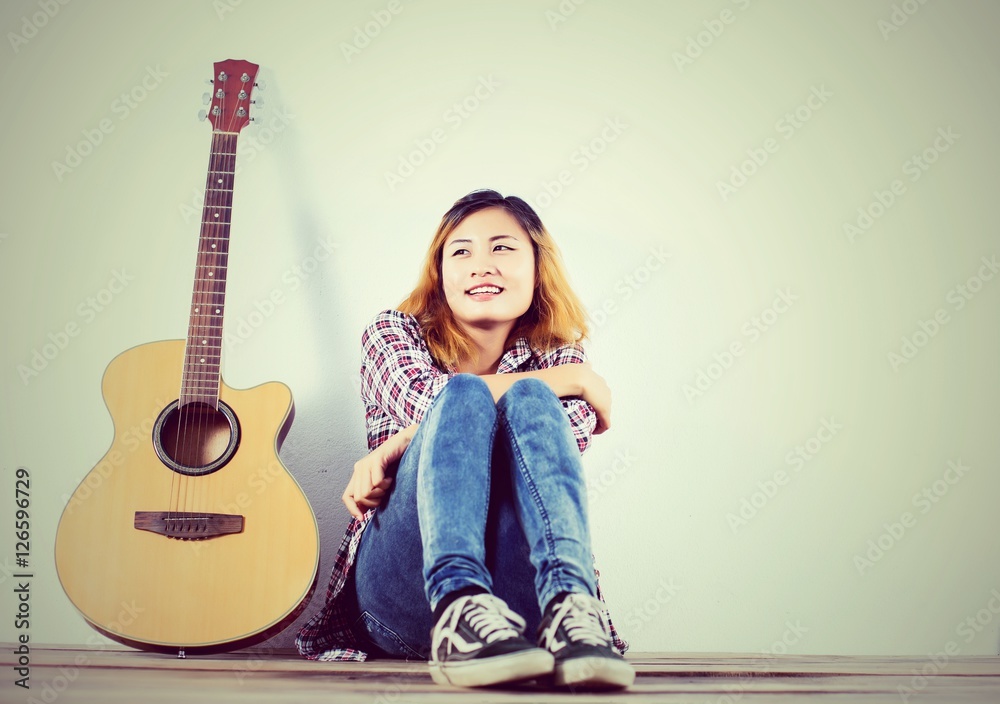 Wall mural hipster woman style portrait enjoy with guitar look so happy.