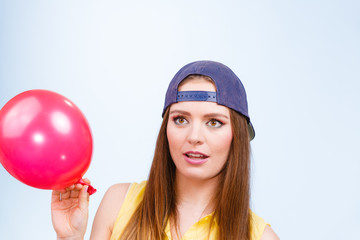 Teenage girl with red balloon.