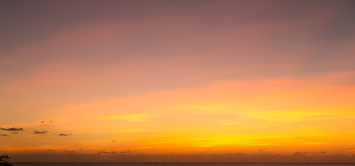 Infinity edge pool with sea underneath sunset