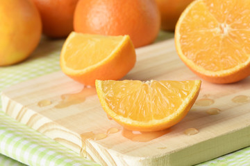 Fototapeta na wymiar Juicy clementine or tangerine, sliced on a cutting board