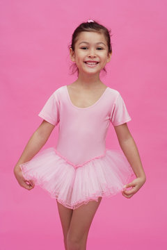 Young girl in ballerina costume, smiling at camera