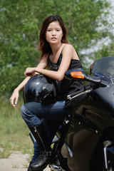 Fototapeta na wymiar Young woman on motorcycle