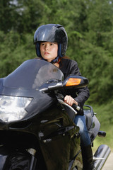 Young woman riding motorbike