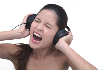 Fototapeta premium Young woman wearing headphones, screaming
