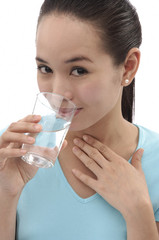 Young woman drinking from a glass of water