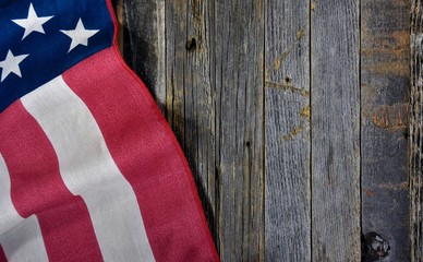 Fototapeta na wymiar close up of American flag on rustic barn wood