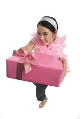 Young woman holding present and smiling at camera