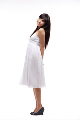 Young girl wearing white dress, side view