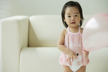 Baby girl with balloon