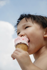 Young boy eating an ice cream cone