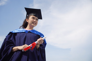 University student in graduation robe cheering