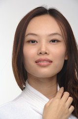 Young woman in bathrobe smiling at camera