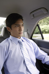 Businessman in backseat of car