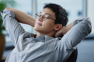 A man relaxes at his desk