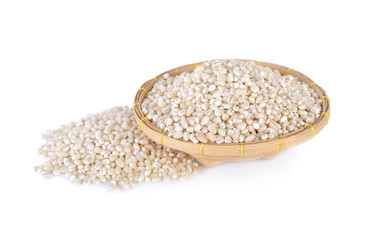 uncooked barley grain in bamboo basket with white background