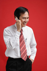 A man smiles as he talks on a cellphone