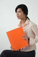 A woman with an orange folder