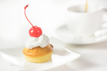 Cup cakes with cream and cherry