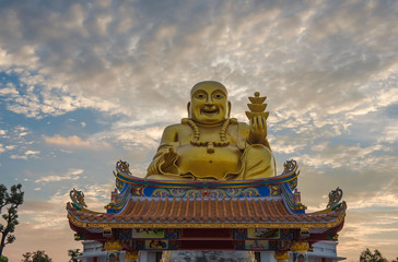 Golden Sangkat Ja Buddha with Twilight sky background.