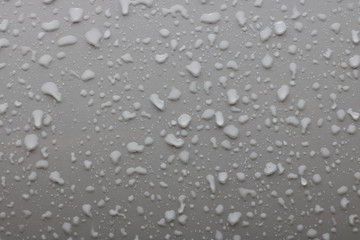 Photo of raindrops on gray metal background